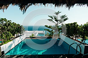 Mykonos luxury hotel: View of Patio deck with infinity pool and bay. Afternoon shot of luxury home.