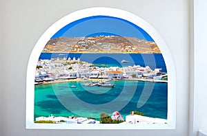 Mykonos port with boats and windmills at evening, Cyclades islands.