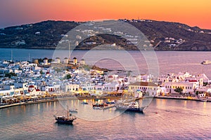 Mykonos port with boats and windmills at evening, Cyclades islands.