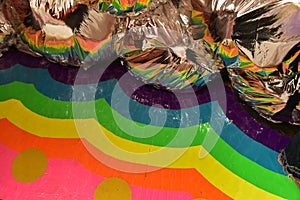Close up of Mylar Balloons and wavy rainbow paint photo