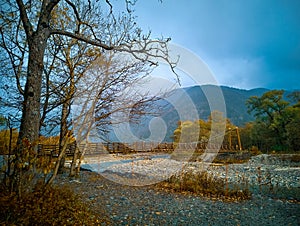 Myojin bridge and Azusa river in late autumn at Kamikochi National Park, Matsumoto, Nagano, Japan