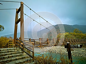 Myojin bridge and Azusa river in late autumn at Kamikochi National Park, Matsumoto, Nagano, Japan