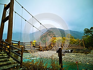 Myojin bridge and Azusa river in late autumn at Kamikochi National Park, Matsumoto, Nagano, Japan