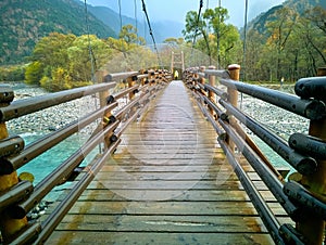 Myojin bridge and Azusa river in late autumn at Kamikochi National Park, Matsumoto, Nagano, Japan