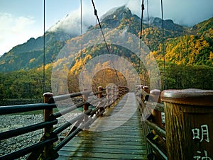 Myojin bridge and Azusa river in late autumn at Kamikochi National Park, Matsumoto, Nagano, Japan