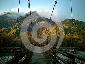 Myojin bridge and Azusa river in late autumn at Kamikochi National Park, Matsumoto, Nagano, Japan