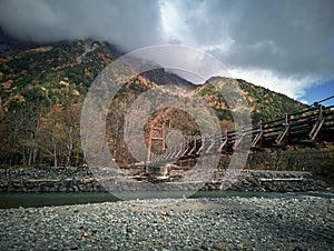 Myojin bridge and Azusa river in late autumn at Kamikochi National Park, Matsumoto, Nagano, Japan