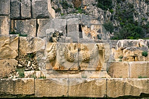 Myra Ancient City. Preserved bas-reliefs with floral ornaments and faces. Demre, Antalya, Turkey