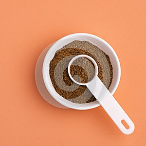 Myristica - Organic nutmeg powder in ceramic bowl