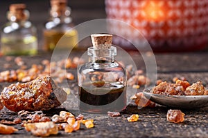 Myrrh essential oil with myrrh resin on a table