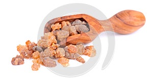 Myrrh resin in olive scoop, isolated on white background. Pile of natural Commiphora myrrha. Sweet Myrrh Opoponax