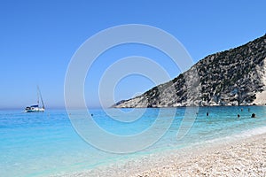 The Myrthos beach with little white stones and crystal clear waters blue
