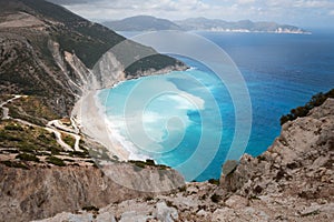 Myrtos Beach - unique turquoise water landmark seashore with a bright white pebbles often proclaimed as one of the best beaches in