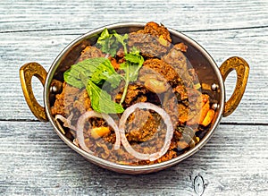 mysore mutton sukka bhuna karahi served in dish isolated on wooden table top view of indian spicy food