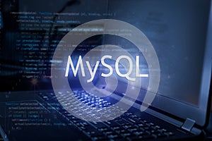 MySQL inscription against laptop and code background. Learn sql programming language, computer courses, training