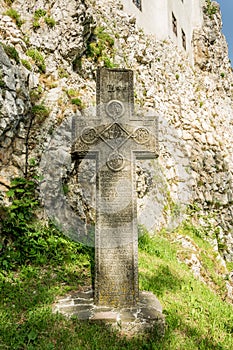 Mysterious ancient stone cross with runic symbols. Landmarks of Bran Castle, Romania