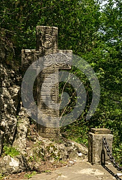 Mysterious ancient stone cross with runic symbols. Landmarks of Bran Castle, Romania