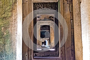 Mysterious Angkor, details. A stone sculpture of the sacred lingam can be seen through the doorway.