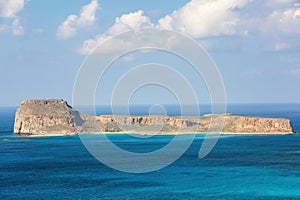 Mysterious Balos bay, island Crete, Greece. In the azure sea there are mountains edged with the water. Sky with clouds. Waves.