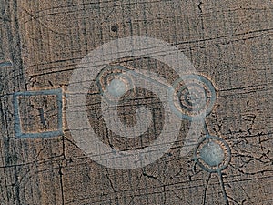 Mysterious crop circle in oat field near the city, aerial view