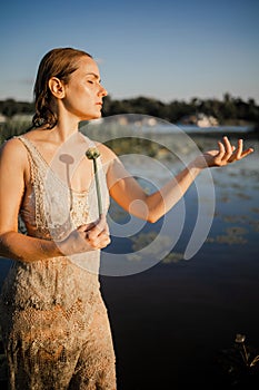 Mysterious And Fashion Portrait Of Young Woman Lying In Water