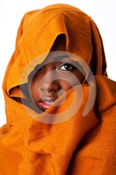 Mysterious female face in ocher head wrap photo