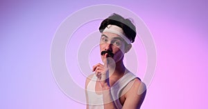 Mysterious Freaky Caucasian Man Making Shh Gesture On Purple Background