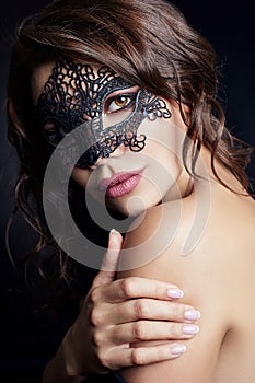 Mysterious girl in a black mask, masquerade. Nude brunette