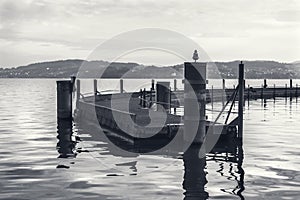Mysterious grayscale shot of a sea dock standing in water