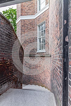 A mysterious and hidden old back alley with staircase in London at night