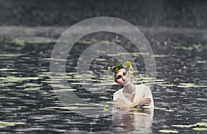 Mysterious image of a beautiful woman in woods. Lonely mysterious girl on background of wild nature. Woman in search of herself