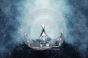 mysterious and magical photo of of beautiful queen/king crown over gothic snowy black background. Medieval period concept