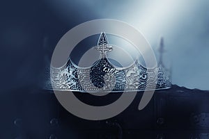 mysterious and magical photo of of beautiful queen/king crown over gothic snowy dark background. Medieval period concept