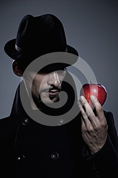 Mysterious man holding an apple
