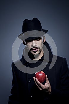 Mysterious man holding an apple