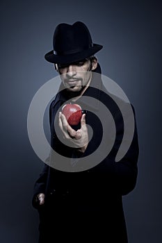 Mysterious man holding an apple