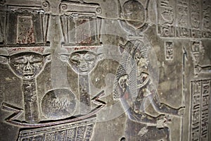 Mysterious murals on the walls of the Temple of Dendera Hathor , near the city of Ken