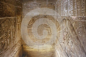 Mysterious murals on the walls of the Temple of Dendera Hathor , near the city of Ken. Electric lamps in the image