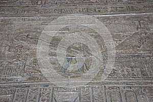 Mysterious murals on the walls of the Temple of Dendera Hathor , near the city of Ken. Electric lamps in the image