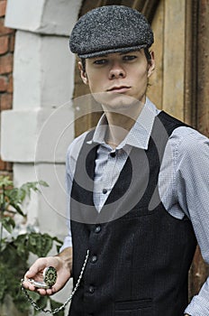 Mysterious portrait of retro 1920s english gangster with flat cap.