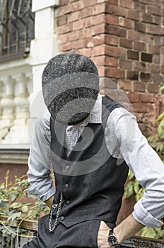 Mysterious portrait of retro 1920s english gangster with flat cap.