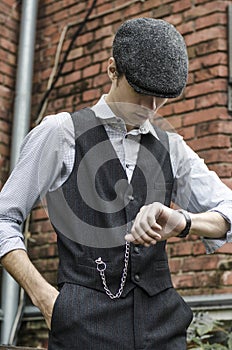 Mysterious portrait of retro 1920s english gangster with flat cap.