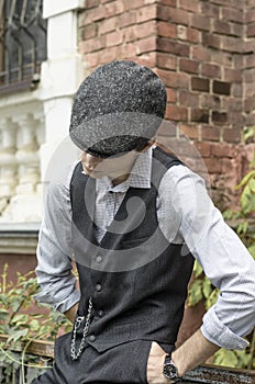 Mysterious portrait of retro 1920s english gangster with flat cap.