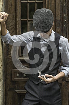 Mysterious portrait of retro 1920s english gangster with flat cap.