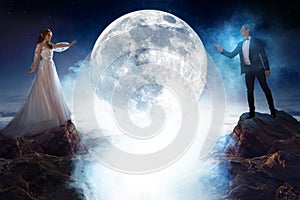 Mysterious and romantic meeting, bride and groom under the moon. Man and woman pulling each other`s hands. Mixed media
