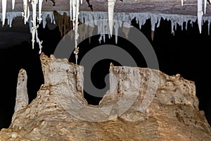 Mysterious Stalagmites and Stalactites in a Dark Cave