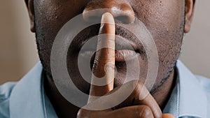 Mysterious unknown male face part african american adult man put finger to lips ask be quiet make gesture silence show