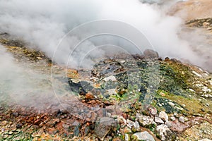 Mysterious view of volcanic landscape, aggressive hot spring, eruption fumarole, gas-steam activity in crater of active