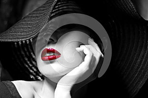 Mysterious woman in black hat. Red lips