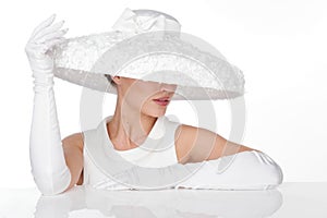 Mysterious Woman in Elegant white Hat and glowes